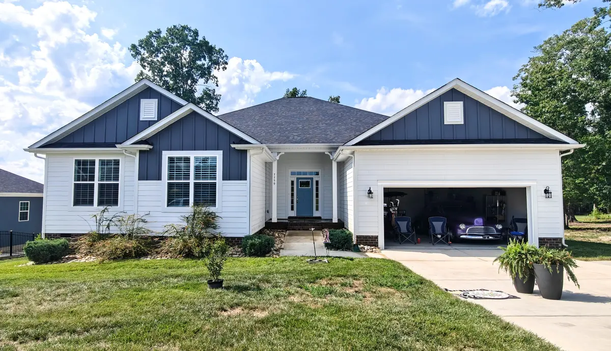 Craftsman-style home near Locust, NC with clean siding and roof under a clear summer sky